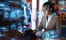 An image depicting a woman working on a computer​