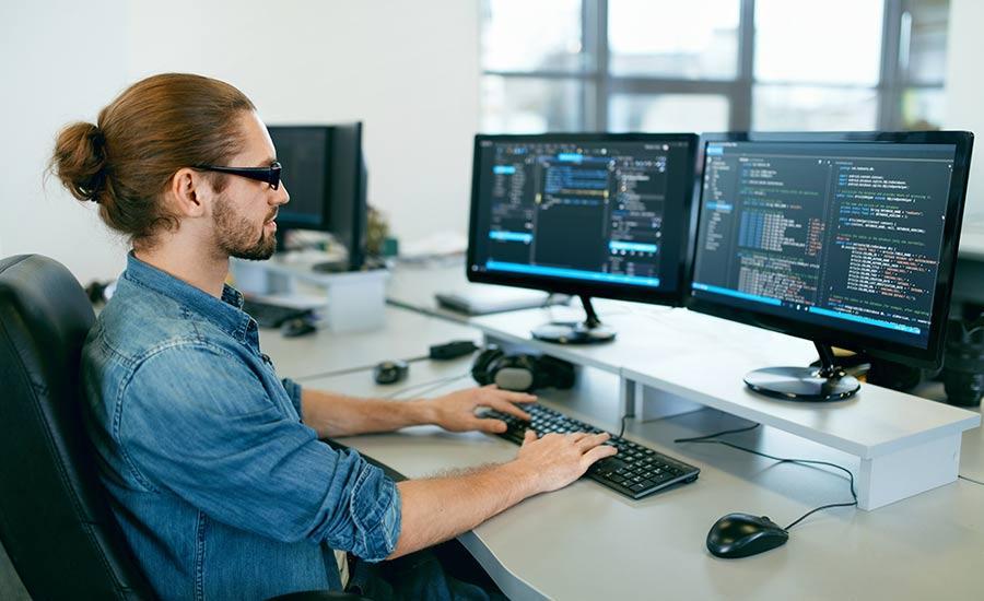 An image depicting a man working on a computer​